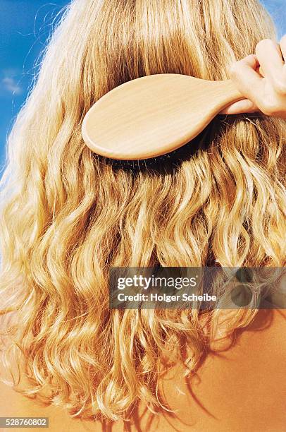 woman brushing her long blonde hair - long hair back stock pictures, royalty-free photos & images