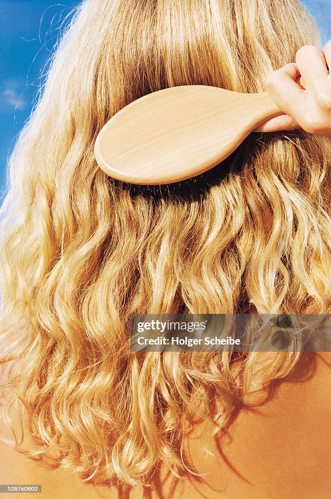 Woman Brushing Her Long Blonde Hair