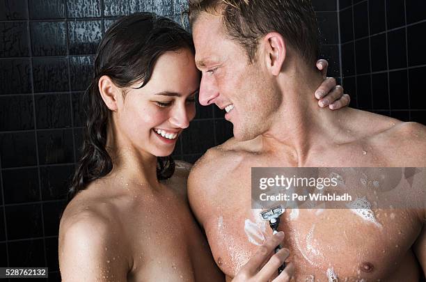 couple taking shower together - shower man woman washing stock pictures, royalty-free photos & images