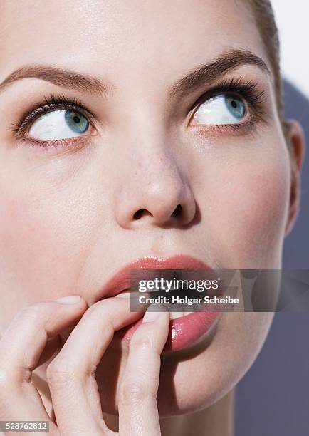 beautiful woman with fingers in mouth - 指をくわえる ストックフォトと画像