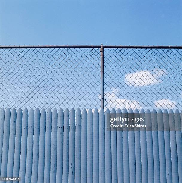 fence before blue sky - barrikade stock-fotos und bilder