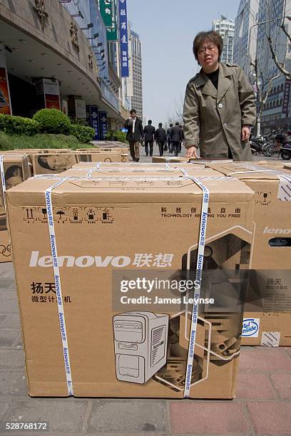 Boxes of Lenovo computers and monitors being readied for delivery on the street in Shanghai. Lenovo is China's largest computer manufacturer and...