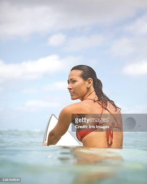 woman on a surfboard - sitting on surfboard ストックフォトと画像