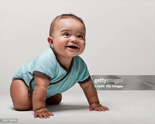 baby boy learning to crawl - infant bodysuit stock pictures, royalty-free photos & images