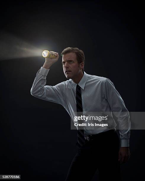 businessman with flashlight - iris mann stock-fotos und bilder