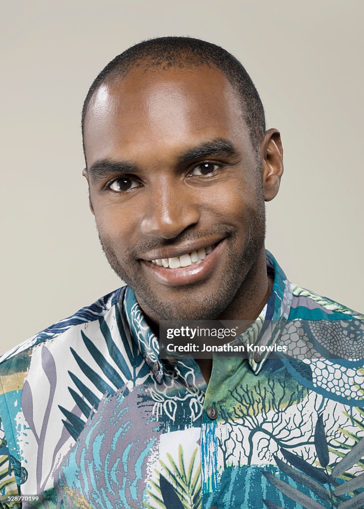 Dark skinned male, looking into camera