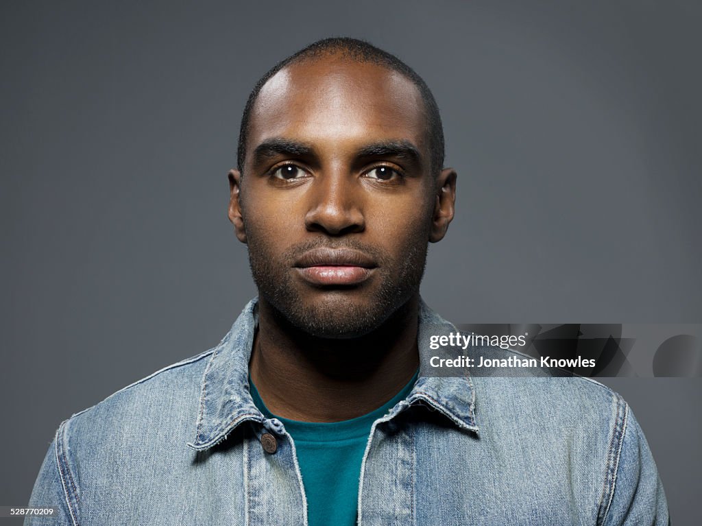 Dark skinned man looking straight into camera