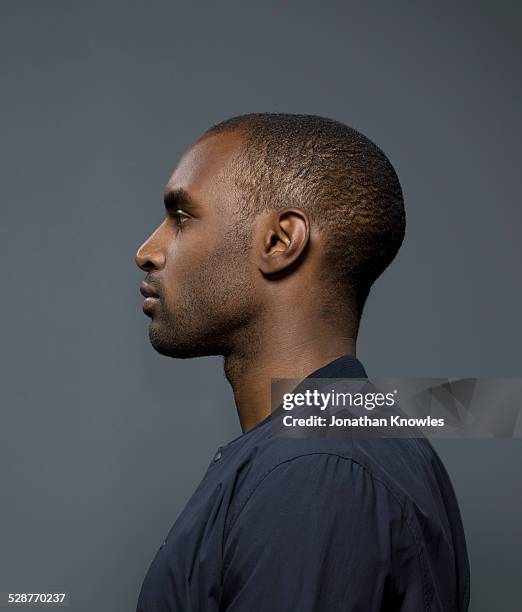 side portrait of a dark skinned male - male portrait stock-fotos und bilder