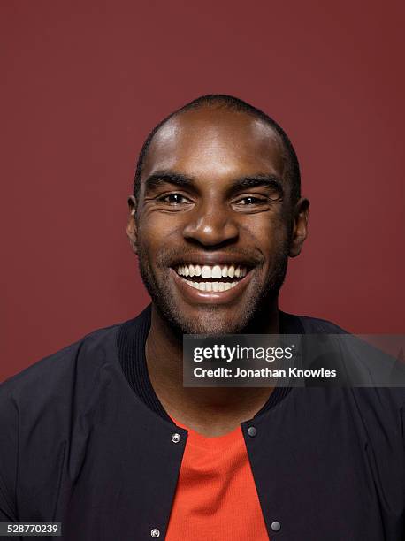portrait of a dark skinned male, smiling - barba por fazer imagens e fotografias de stock