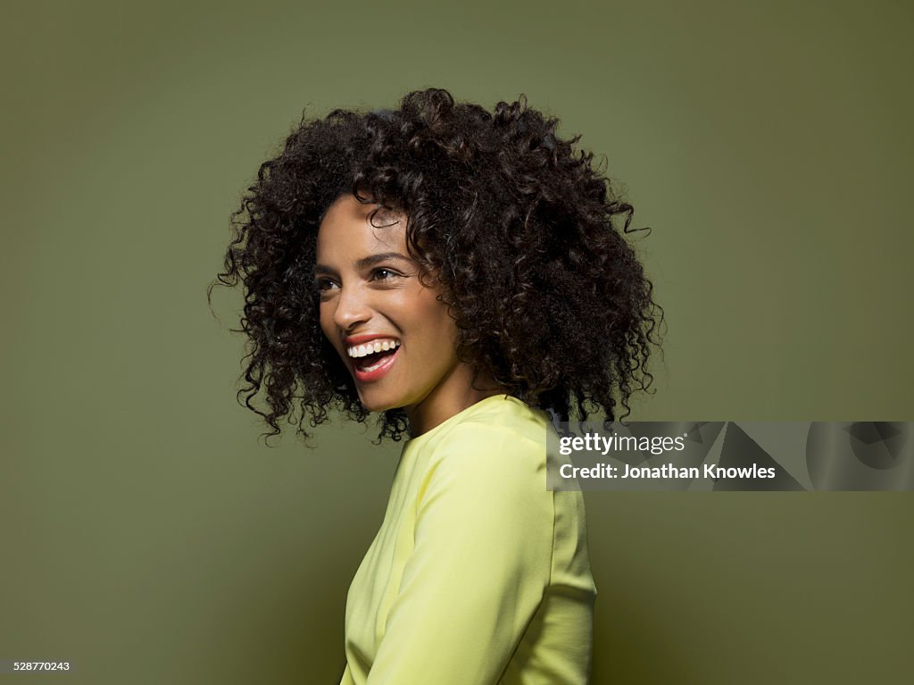 Side portrait of a dark skinned female, laughing