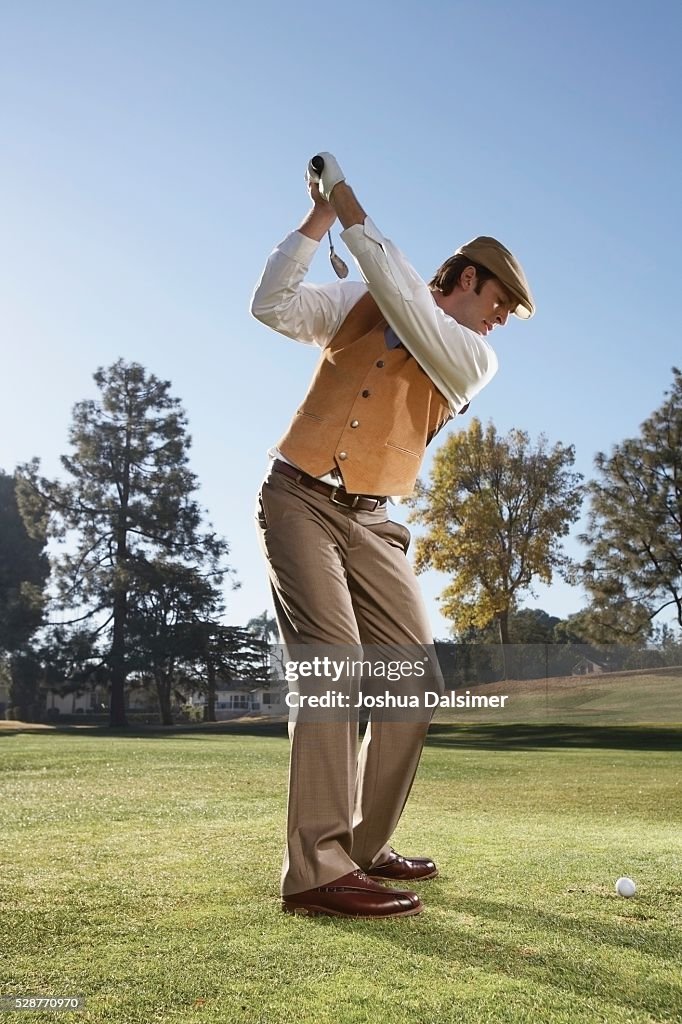 Man Preparing to Swing a Golf Club