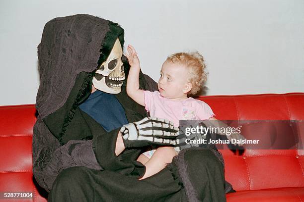 person in costume holding baby - irony stock pictures, royalty-free photos & images