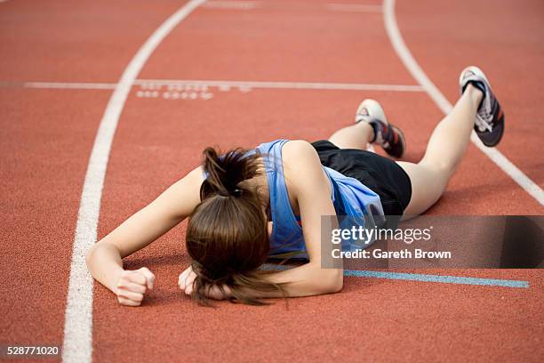 runner lying on track - stumble stock pictures, royalty-free photos & images