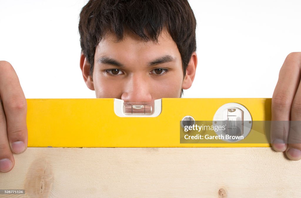 Young Man With A Level High-Res Stock Photo - Getty Images