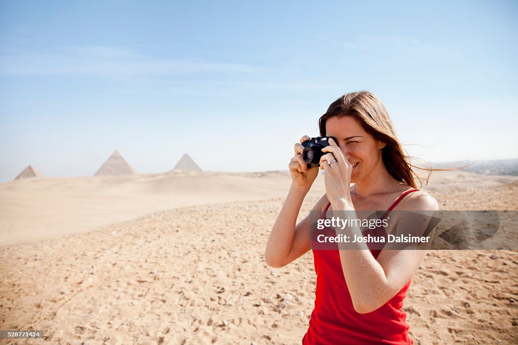 Woman taking pictures in the desert