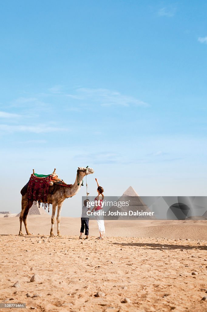 Mother and son with a camel