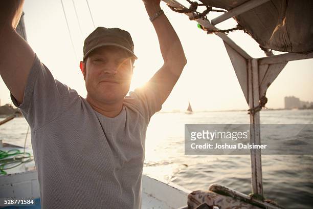 man on a boat - joshua dalsimer stock pictures, royalty-free photos & images