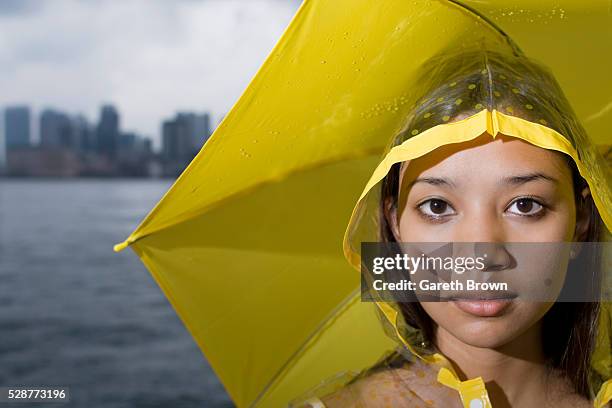 woman in raincoat with umbrella - vintage raincoat stock-fotos und bilder