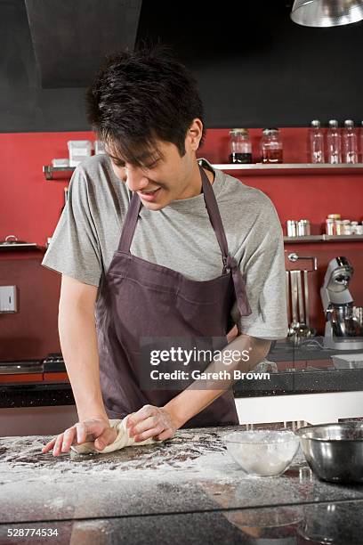 man baking - kneading stock pictures, royalty-free photos & images