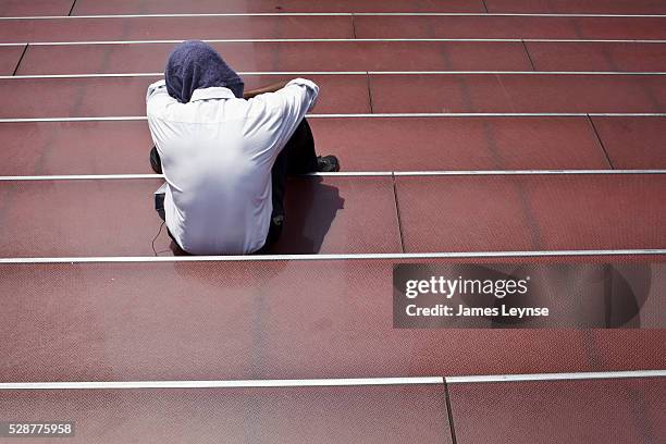 Man covers his head from the sun in Times Square on the fourth day of a heat wave that has brought temperatures above 100 degrees Fahrenheit to much...