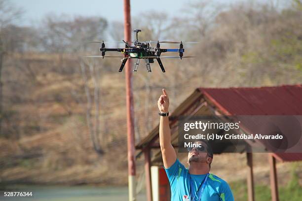 creative businessman operates an unmanned aerial vehicle (uav). - octocopter stock pictures, royalty-free photos & images