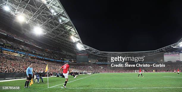 Manchester United's Ryan Giggs takes a corner kick in front of a packed stadium during the match against A-League All Stars at Stadium Australia,...