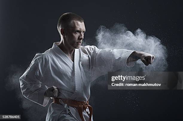 brave fighter in kimono doing karate - aikido stock pictures, royalty-free photos & images