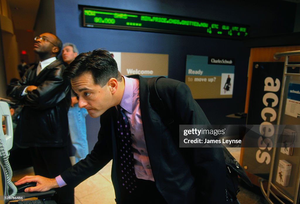 Man Checking Terminal in Charles Schwab Office