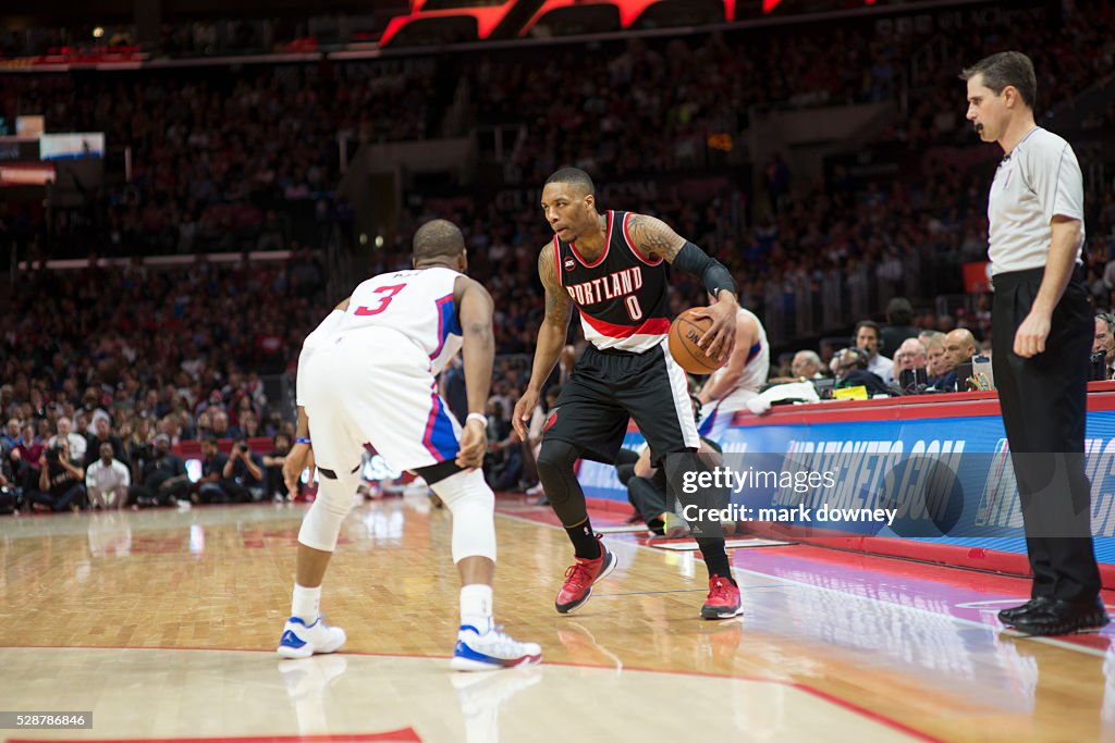 Damian Lillard prepares to drive on Chris Paul