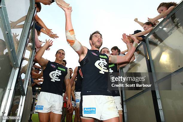 Dale Thomas of the Blues celebrates with supportres in the crowd as he leaves the ground after the Blues won the round seven AFL match between the...