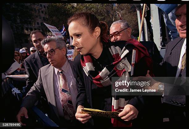 The exiled daughter of Fidel Castro is escorted by bodyguards during an anti-Castro protest.