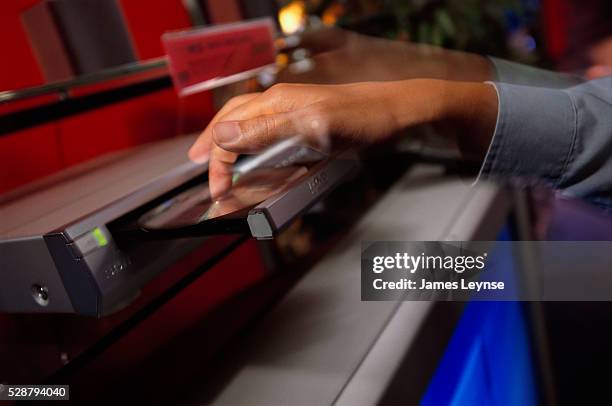 Shopper tests a DVD player on display at The Wiz.