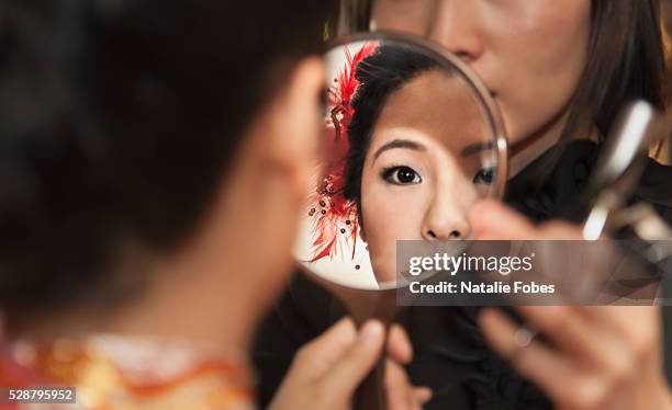 chinese bride in traditional-style gown gets makeup applied - chinese tradition stock pictures, royalty-free photos & images