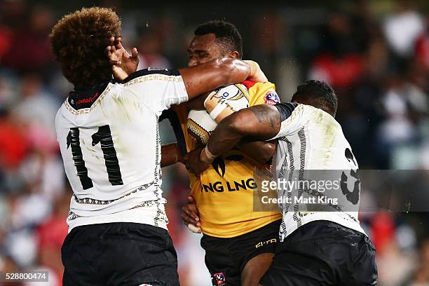 Kato Ottio of Papua New Guinea is tackled during the International Rugby League Test match between Fiji and Papua New Guinea at Pirtek Stadium on May...