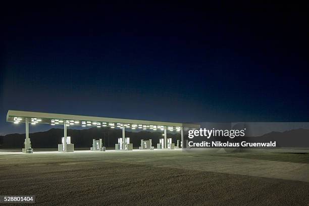 gas station somewhere in the desert - gas station night stock pictures, royalty-free photos & images