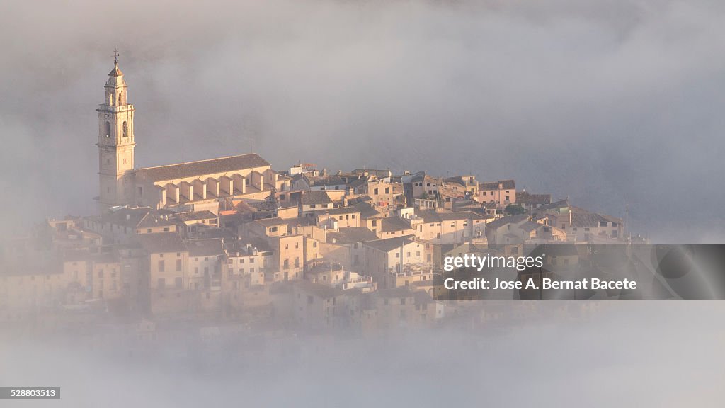 Medieval people surrounded with fog to the dawn