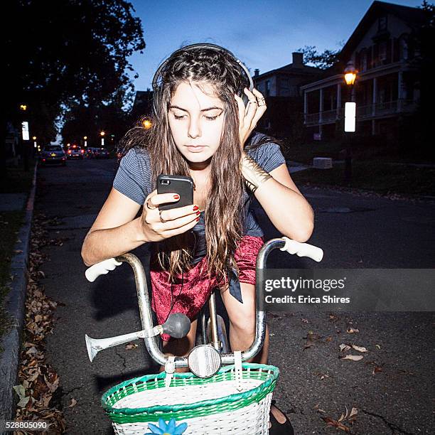 young adult woman on bike using her cell phone - bicycle in the night bildbanksfoton och bilder