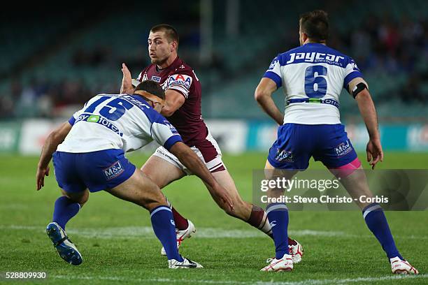 Manly's Kieran Foran is tackled by Bulldogs Dale Finucane and Josh Reynolds during the match at Allianz Stadium. Sydney, Australia. Saturday 20th...