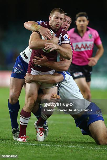 Manly's Kieran Foran is tackled by Bulldogs Dale Finucane and Josh Reynolds during the match at Allianz Stadium. Sydney, Australia. Saturday 20th...