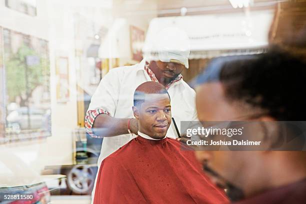 man having hair cut in barber shop - joshua dalsimer stock pictures, royalty-free photos & images