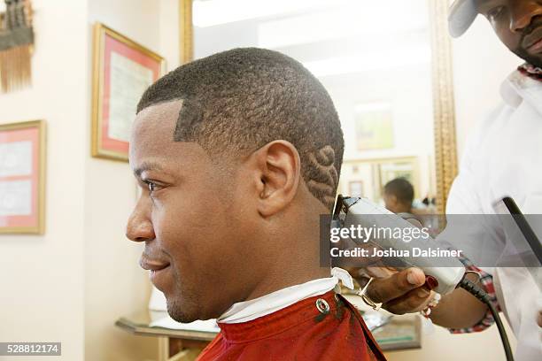 man having hair cut in barber shop - joshua dalsimer stock pictures, royalty-free photos & images