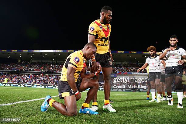 Watson Boas of Papua New Guinea celebrates victory with Kato Ottio of Papua New Guinea at the end of the International Rugby League Test match...