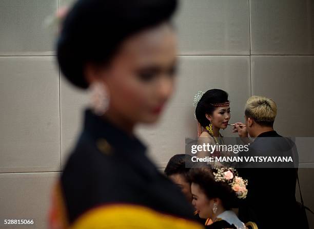 Malaysian woman from the indigenous Kadazandusun community of Sabah gets her make-up done before taking part in the annual "Unduk Ngadau Kaamatan", a...