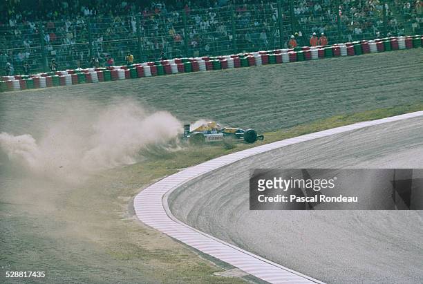 Nigel Mansell of Great Britain spins into the gravel trap on lap 9 driving the Canon Williams Renault Williams FW14 Renault RS3 V10 during the Fuji...