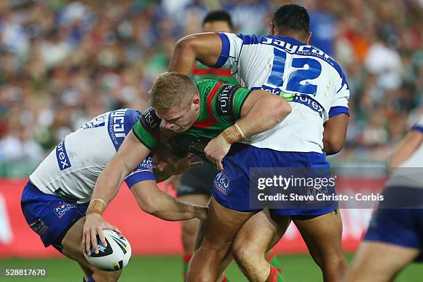 Rabbitohs george Burgess is tackled by Bulldogs Tony Williams and Trent Hodkinson during the NRL Grand Final match at ANZ Stadium 2014. Sydney,...