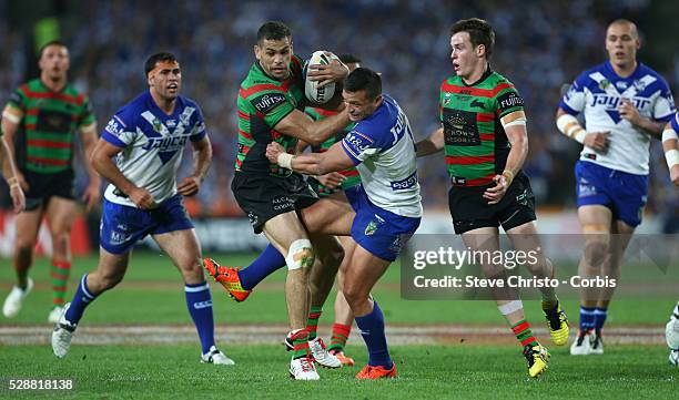 Rabbitohs Greg Inglis fends off Bulldogs Sam Perrett in this tackle during the NRL Grand Final match at ANZ Stadium 2014. Sydney, Australia. Sunday...