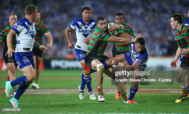 Rabbitohs Greg Inglis fends off Bulldogs Sam Perrett in this tackle during the NRL Grand Final match at ANZ Stadium 2014. Sydney, Australia. Sunday...