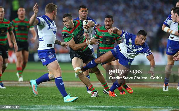 Rabbitohs Greg Inglis fends off Bulldogs Sam Perrett in this tackle during the NRL Grand Final match at ANZ Stadium 2014. Sydney, Australia. Sunday...