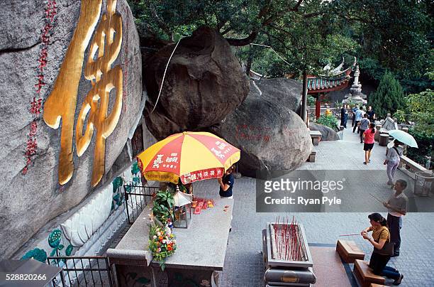 Visitors pray at the Nanputuo Temple in Xiamen. The Nanputuo Temple is located on the southeast of Xiamen Island. It is surrounded by the graceful...