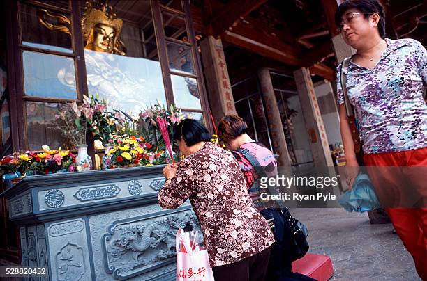 Visitors pray in front of the Hall of Heavenly King at the Nanputuo Temple in Xiamen. The Nanputuo Temple is located on the southeast of Xiamen...